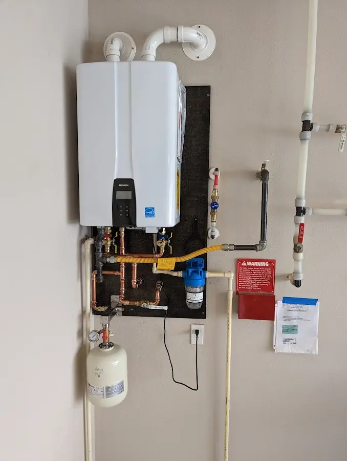 Professional plumber installing copper piping in a Huntsville home